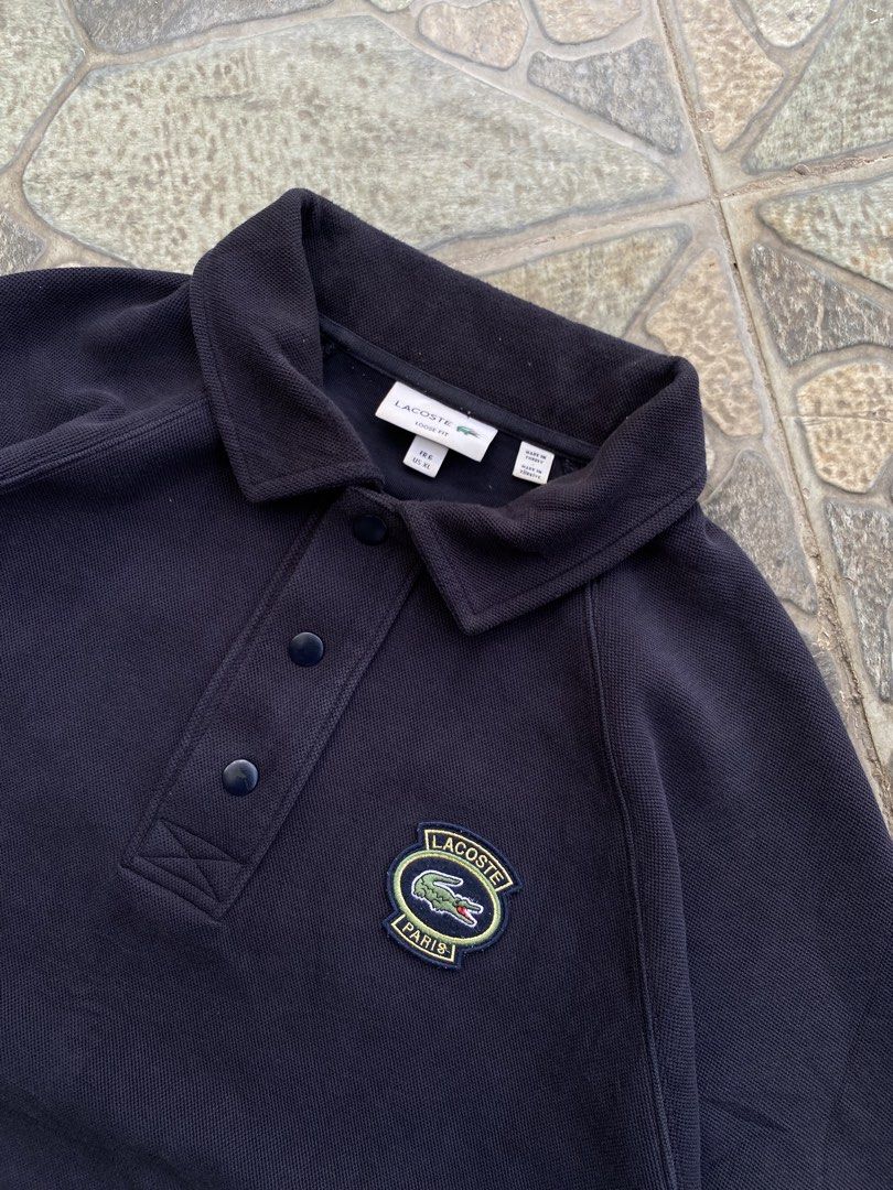 Lacoste Paris Navy Blue Sweatshirt Polo (Category: Coats, Jackets and Outerwear) located in Alicia. Submitted by wunna1_sham (Listing ID 1463000415, Image 2). Description: - Navy blue Lacoste Paris sweatshirt - Classic polo collar with button closure - Embroidered Lacoste Paris logo on the chest - Raglan sleeves for a comfortable fit - Ideal for casual wear.