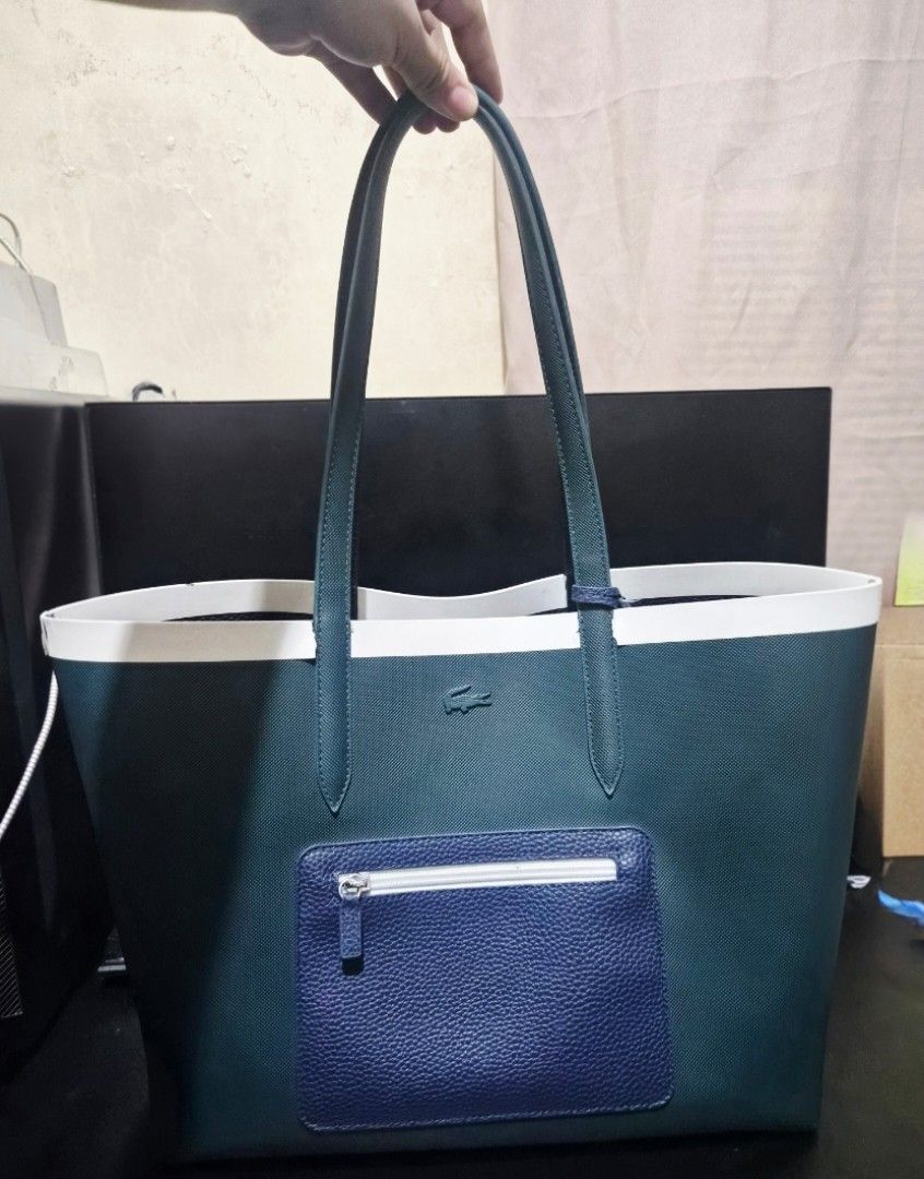 Lacoste Reversible Shopper Bag (Category: Tote Bags) located in Mandaluyong City. Submitted by Mshy09 (Listing ID 1462994125, Image 1). Description: Authentic, bought from Zalora (see last photo) Reversible tote in blue and dark green colorway. Fits a 13-15" laptop comfortably.