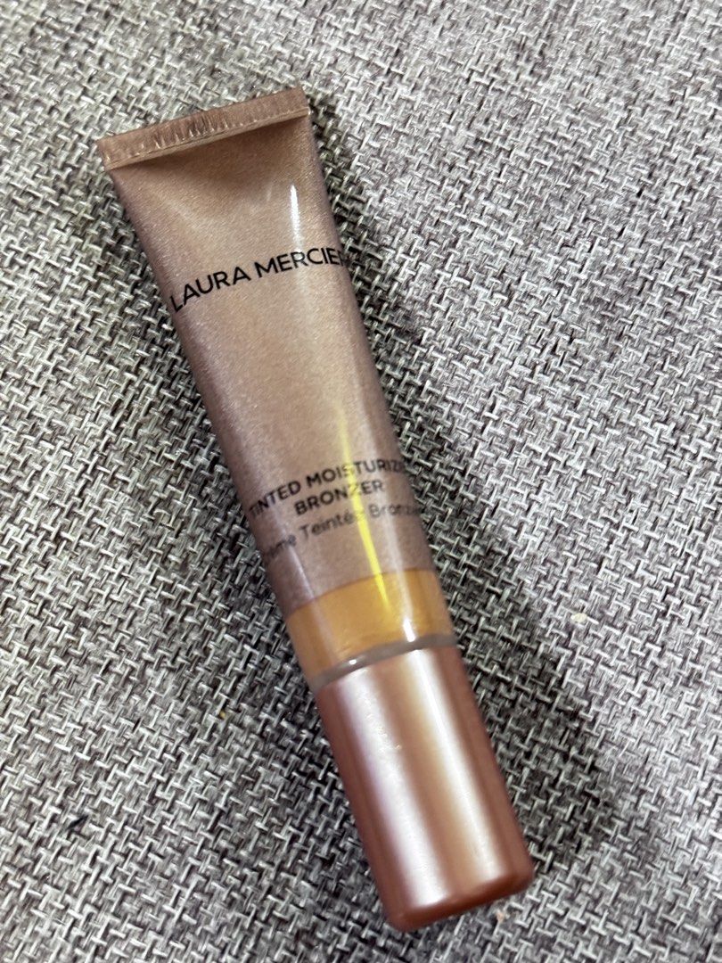 Laura Mercier Tinted Moisturizer Bronzer - Sunlight 04 (Category: Makeup) located in Manila. Submitted by rustmakeupinc (Listing ID 1463038105, Image 1). Description: - Laura Mercier Tinted Moisturizer Bronzer - Shade: 04 Sunlight - Size: 15ml tube - Creates a natural, sun-kissed glow - Easy to blend for a seamless finish - Use a small amount for desired effect.