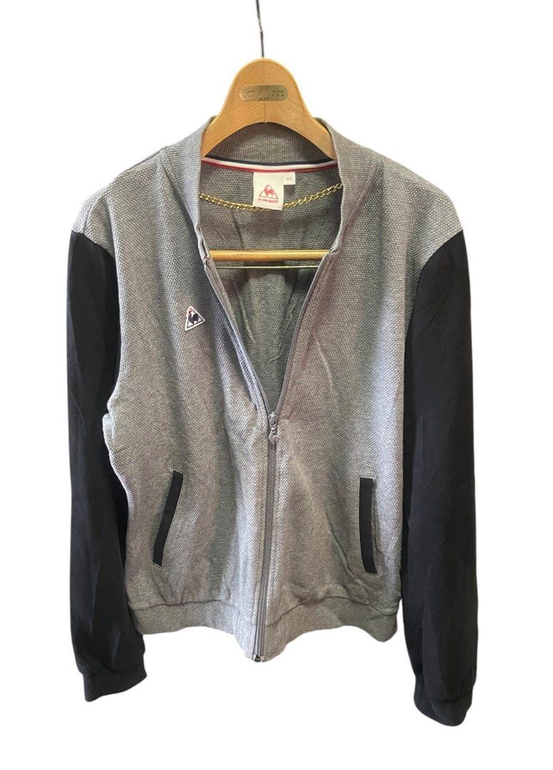 Le Coq Sportif Bomber Jacket Grey Black (Category: Coats, Jackets and Outerwear) located in San Pedro. Submitted by lifebeginsaftercoff33 (Listing ID 1463113355, Image 3). Description: - Le Coq Sportif bomber jacket for Woman - Color: Grey body with black sleeves - Features: Zip-up front, pockets - Detail: Small rooster logo on chest - Condition: Good - Style: Perfect for casual wear - Dimes: 21 x 24 in - Very soft comfy stretchy fabric.
