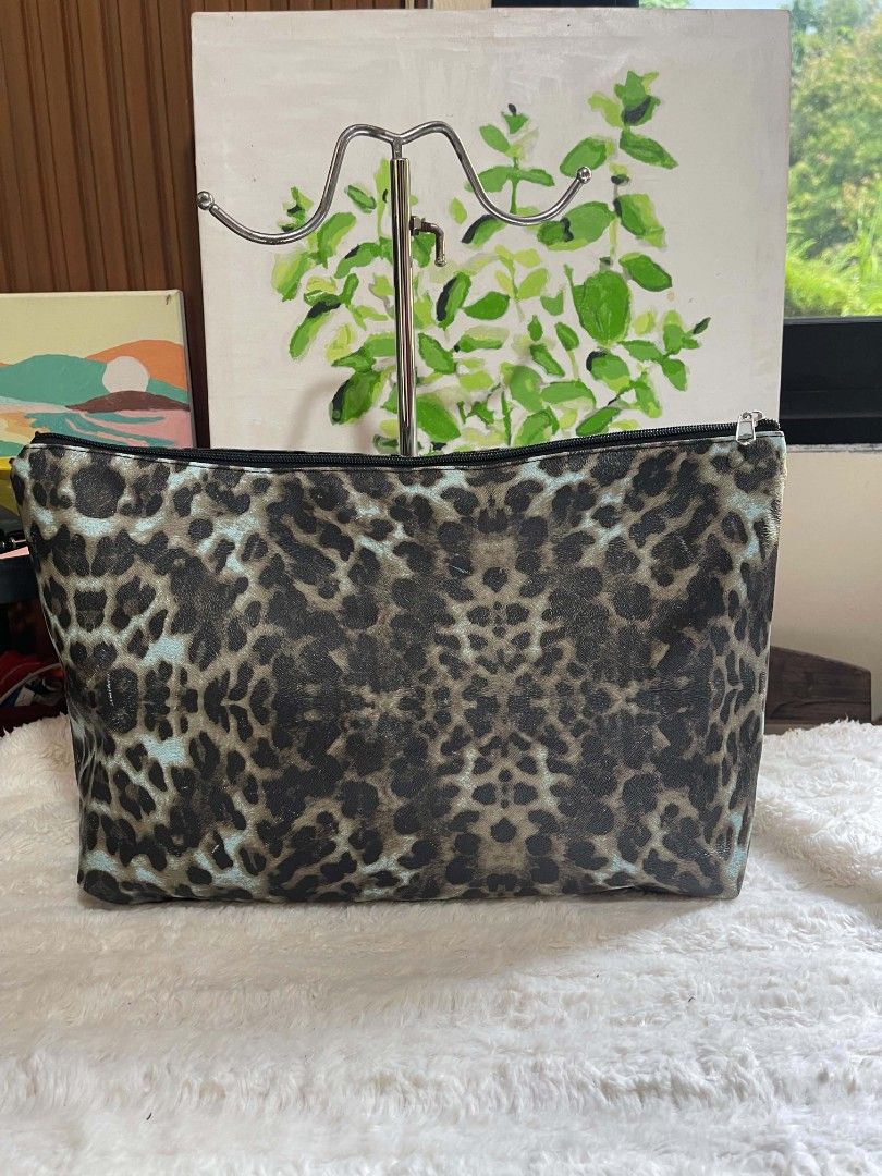 Leopard Print Bag Pouch (Category: Purses & Pouches) located in Naawan. Submitted by twilly.apparel2 (Listing ID 1462916911, Image 1). Description: - Adorable leopard print design - Versatile use: makeup, toiletries, or general storage - Secure zipper closure - Spacious interior for all your essentials - Convenient size: approximately 13 inches wide - Easy-to-clean material for hassle-free maintenance - Perfect for travel or everyday organization