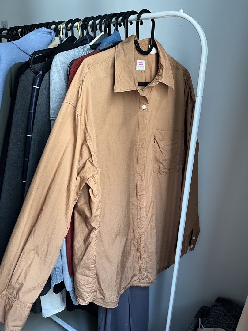 Levi's Brown Button-Up Shirt Size S (Category: Tshirts & Polo Shirts ) located in Dasmarinas. Submitted by 365daysofsummer (Listing ID 1462912378, Image 1). Description: - Brand: Levi's - Color: Brown - Style: Long-sleeved shirt - Features: Chest pocket, button-up front - Texture: Slightly crinkled fabric - Size: Tagged S - Occasion: Casual wear, layering - only used few times - RFS: i dont really know how to style it or hindi lang sya bagay sake