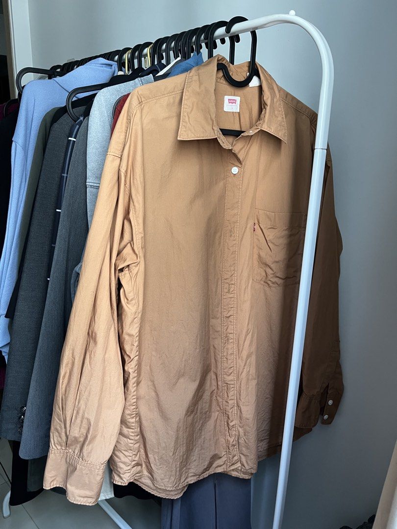 Levi's Brown Button-Up Shirt Size S (Category: Tshirts & Polo Shirts ) located in Dasmarinas. Submitted by 365daysofsummer (Listing ID 1462912378, Image 2). Description: - Brand: Levi's - Color: Brown - Style: Long-sleeved shirt - Features: Chest pocket, button-up front - Texture: Slightly crinkled fabric - Size: Tagged S - Occasion: Casual wear, layering - only used few times - RFS: i dont really know how to style it or hindi lang sya bagay sake