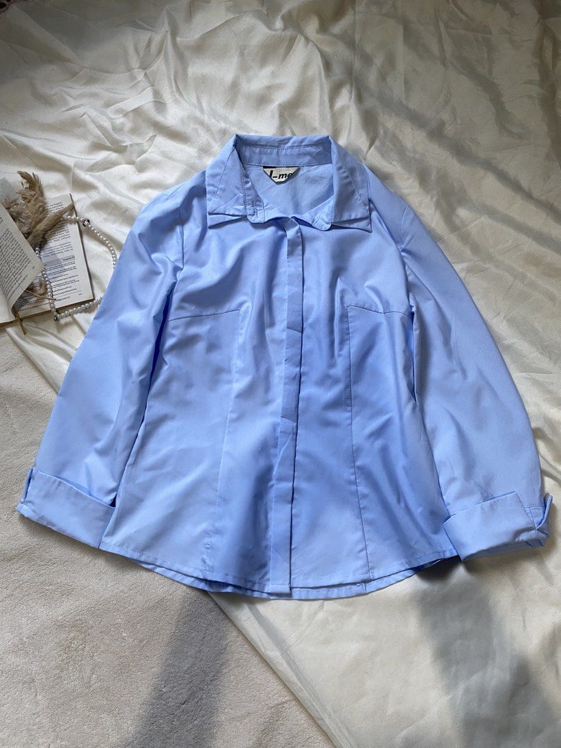 Light Blue Button-Up Shirt Small 33 (Category: Tshirts & Polo Shirts ) located in Poro. Submitted by joyceyuu (Listing ID 1462925359, Image 1). Description: - Classic light blue button-up shirt - Long sleeves with cuffs - Button closure down the front - Tailored fit with darts - Versatile for work or casual wear - Looks great tucked in or worn open.