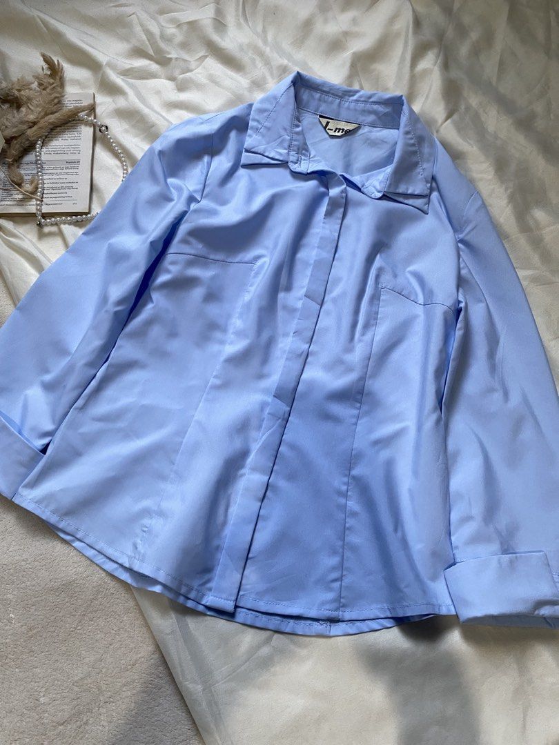 Light Blue Button-Up Shirt Small 33 (Category: Tshirts & Polo Shirts ) located in Poro. Submitted by joyceyuu (Listing ID 1462925359, Image 2). Description: - Classic light blue button-up shirt - Long sleeves with cuffs - Button closure down the front - Tailored fit with darts - Versatile for work or casual wear - Looks great tucked in or worn open.