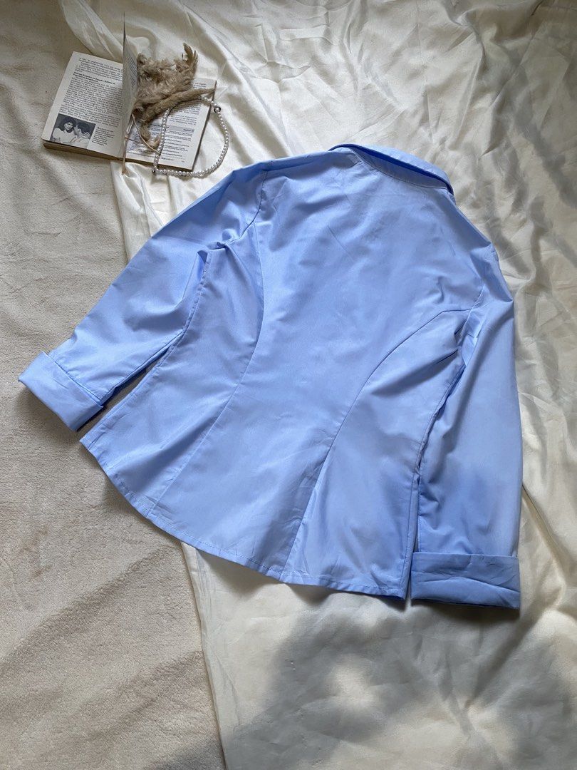 Light Blue Button-Up Shirt Small 33 (Category: Tshirts & Polo Shirts ) located in Poro. Submitted by joyceyuu (Listing ID 1462925359, Image 3). Description: - Classic light blue button-up shirt - Long sleeves with cuffs - Button closure down the front - Tailored fit with darts - Versatile for work or casual wear - Looks great tucked in or worn open.