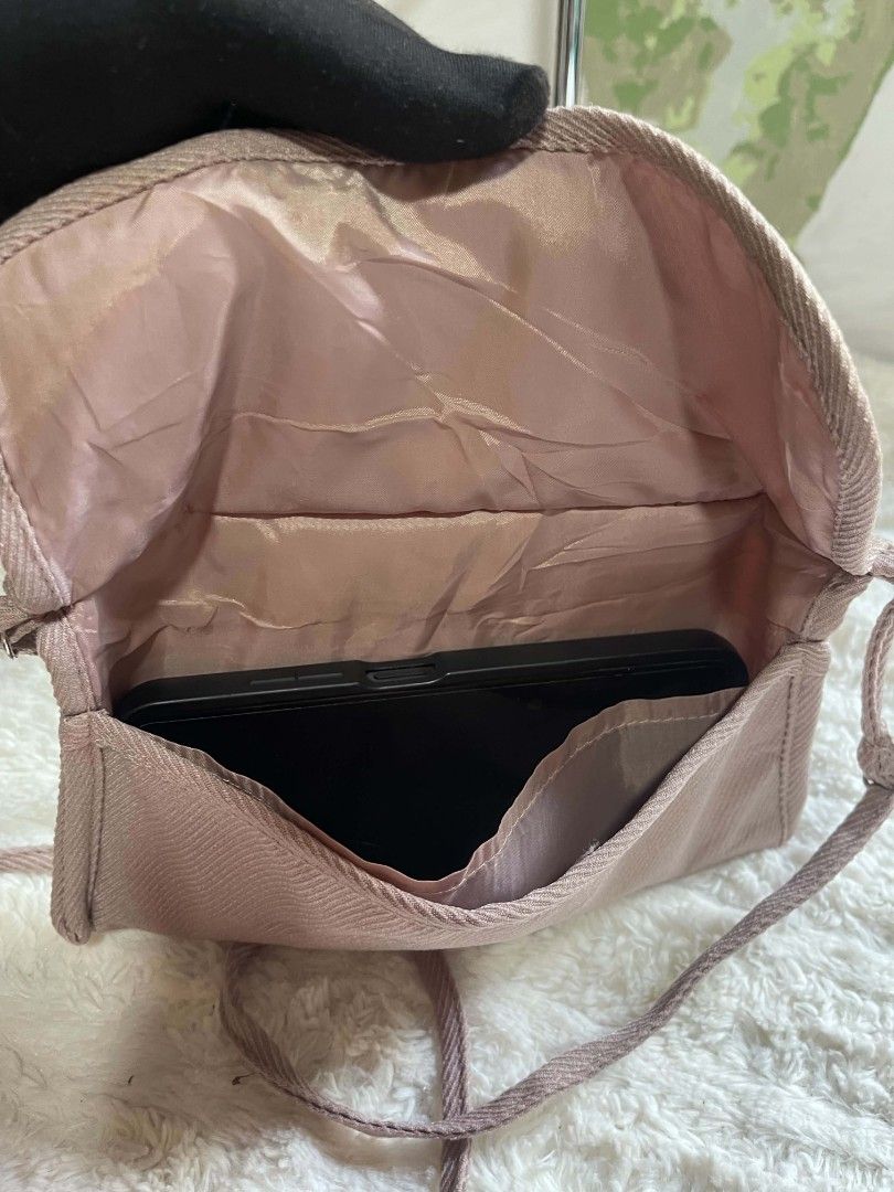 Light Pink Textured Crossbody Bag with Adjustable Strap (Category: Cross-body Bags) located in Naawan. Submitted by twilly.apparel2 (Listing ID 1462956805, Image 2). Description: - Cute textured crossbody bag - Light pink/mauve shade - Long adjustable strap - Interior pockets for organization - Fits phone easily - Ideal for daily necessities - Simple and practical design.