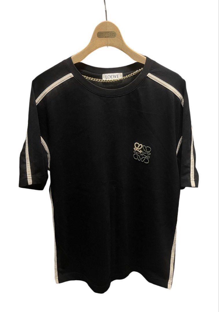 Loewe Black T-shirt Unisex (Category: Tshirts & Polo Shirts ) located in San Pedro. Submitted by lifebeginsaftercoff33 (Listing ID 1463020644, Image 3). Description: - Loewe black t-shirt Unisex - Dimes: 20 x 26 in - Iconic embroidered Loewe anagram logo on chest - Stylish striped detailing along shoulders and sleeves - Classic crew neck design - Ideal for everyday casual wear - Very soft comfy stretchy thick fabric - Made in Portugal.