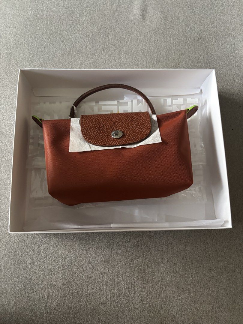 Longchamp Le Pliage Cuir Top Handle Bag (Category: Luxury Bags & Wallets) located in Mandaluyong City. Submitted by rnsa.amn (Listing ID 1462951882, Image 1). Description: BRAND NEW. NO SLING. - Authentic Rustan's Le Pliage Cuir top handle bag - Stunning burnt orange color - Comes with original Rustan's box, dust bag, and tags - Versatile for everyday use or special events RFS: Given as a gift Address: Near McDonalds New Panaderos (Mandaluyong Ci