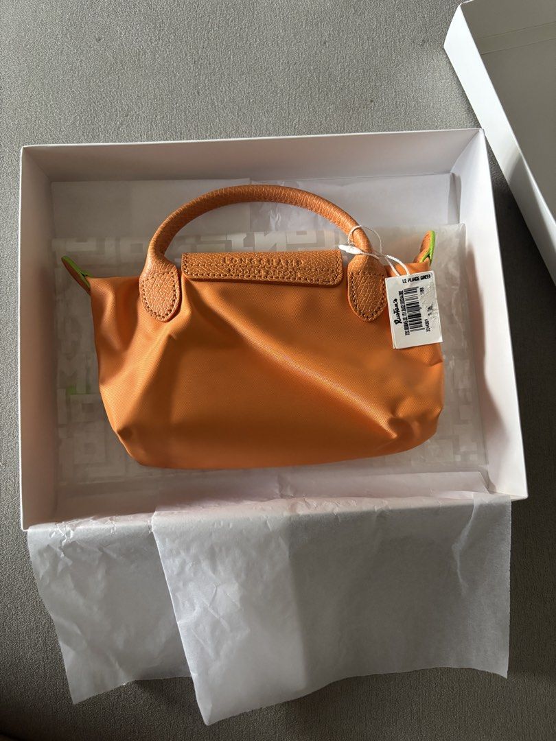 Longchamp Le Pliage Pouch Orange (Category: Purses & Pouches) located in Mandaluyong City. Submitted by rnsa.amn (Listing ID 1462952232, Image 2). Description: - Bright orange Longchamp pouch - Small size, ideal for essentials - Signature Longchamp logo embossed on flap - Leather handles and trim - Comes with original Rustan's box RFS: Given as a gift Address: Near McDonalds New Panaderos MOP: BPI transfer, GCash Delivery and shipping fee c/o buy