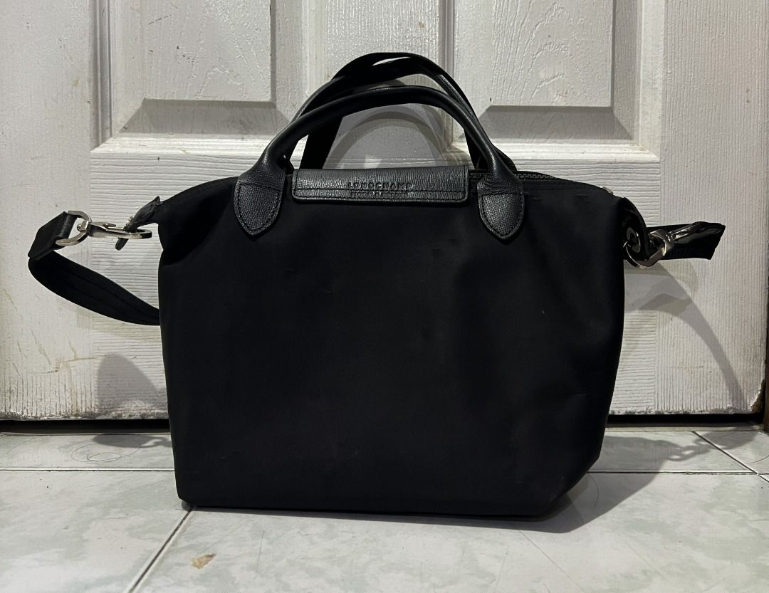 Longchamp Le Pliage Top Handle Bag (Category: Luxury Bags & Wallets) located in Manila. Submitted by hyper.hertz. (Listing ID 1462900577, Image 2). Description: - Authentic black Longchamp bag - Made of durable nylon with genuine leather trim - Versatile carrying options: top handles and detachable shoulder strap .