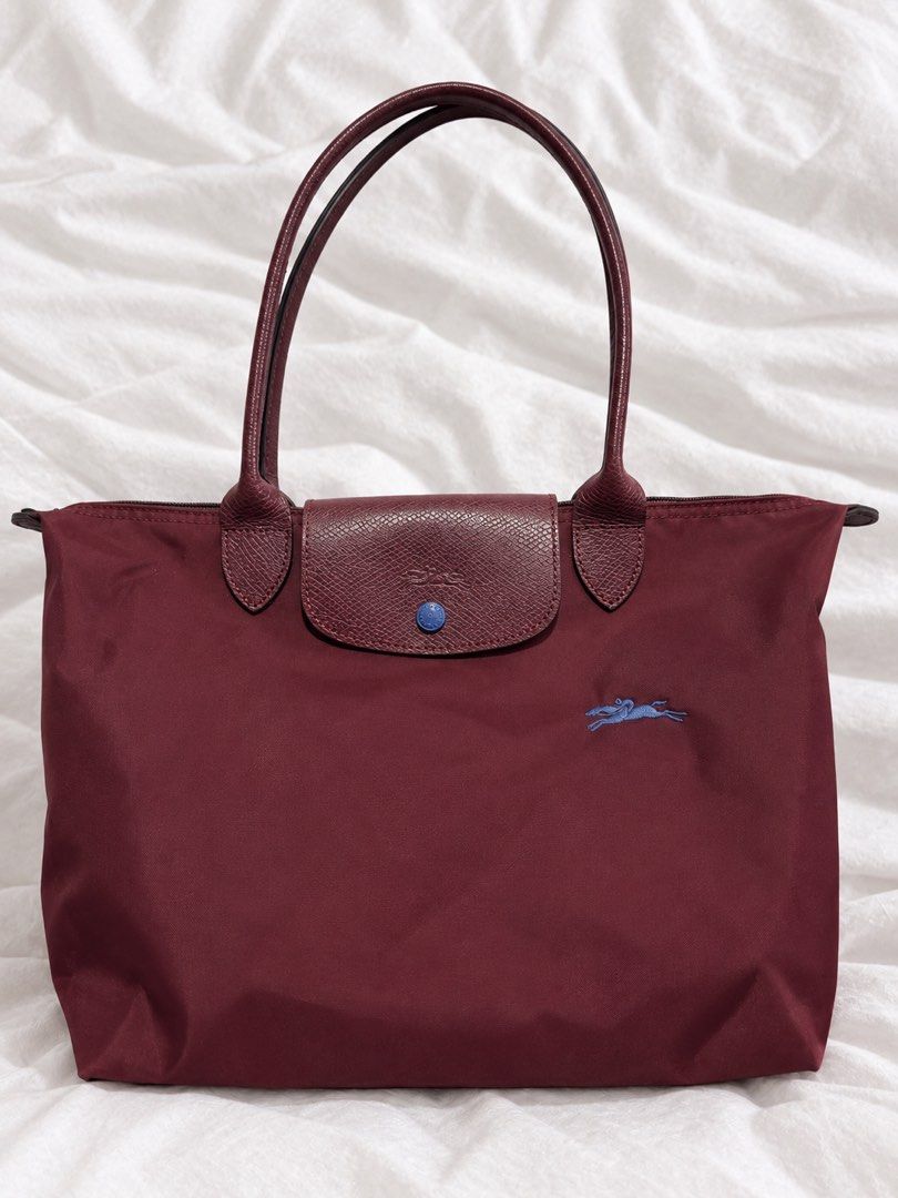 Longchamp Le Pliage Tote Bag Burgundy (Category: Luxury Bags & Wallets) located in Manila. Submitted by royalbear_87f903 (Listing ID 1462928313, Image 1). Description: Classic Longchamp Le Pliage tote. Burgundy color with leather handles and trim. Features the signature embroidered horse logo. Zipper closure with a snap button flap. Great for everyday use, fits a lot. Handles are a deep red color..