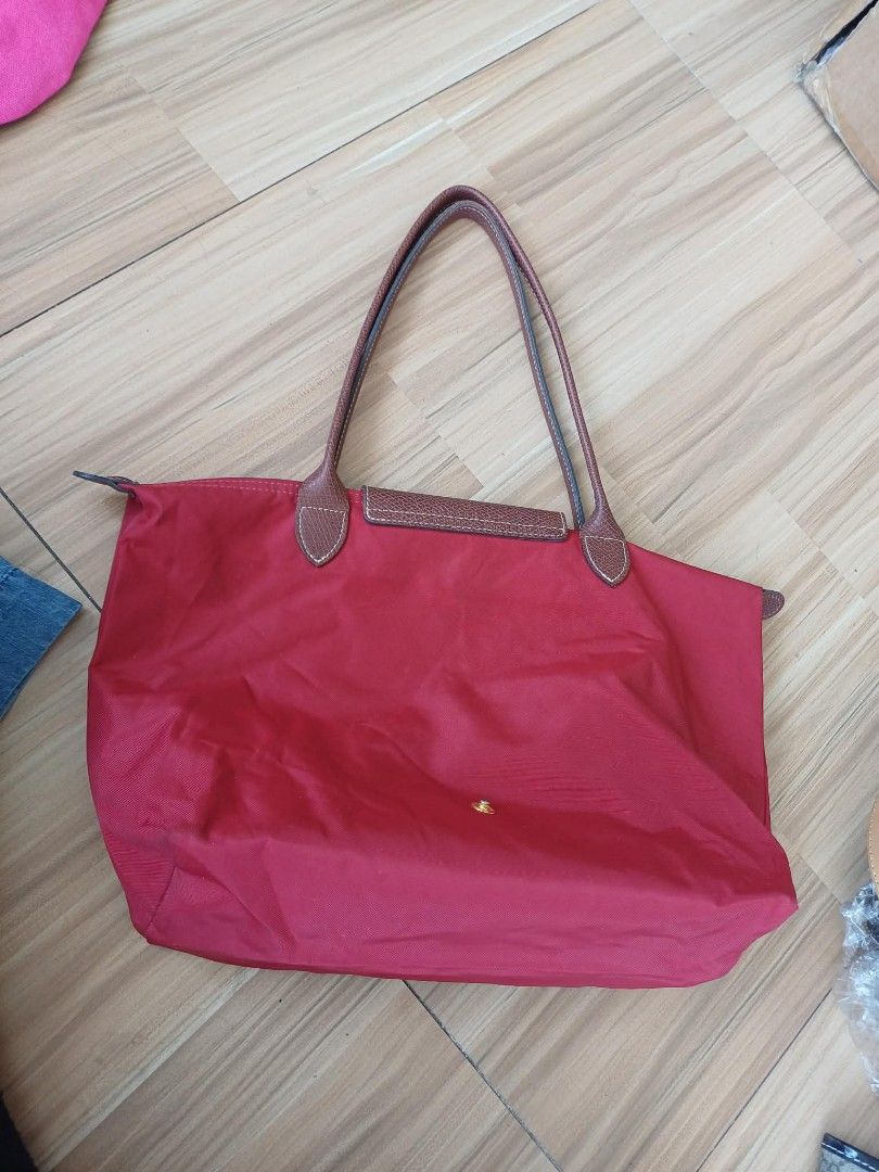 Longchamp Le Pliage Tote Bag Red (Category: Luxury Bags & Wallets) located in Bay. Submitted by silverhorse-59c851 (Listing ID 1463102924, Image 2). Description: - Classic Longchamp tote bag in a vibrant red. - Made with durable nylon and genuine leather handles. - Ample interior space for all your essentials. - Features a convenient small inner pocket. - Folds down easily for compact storage. - Ideal everyday bag for work, errands, or travel..