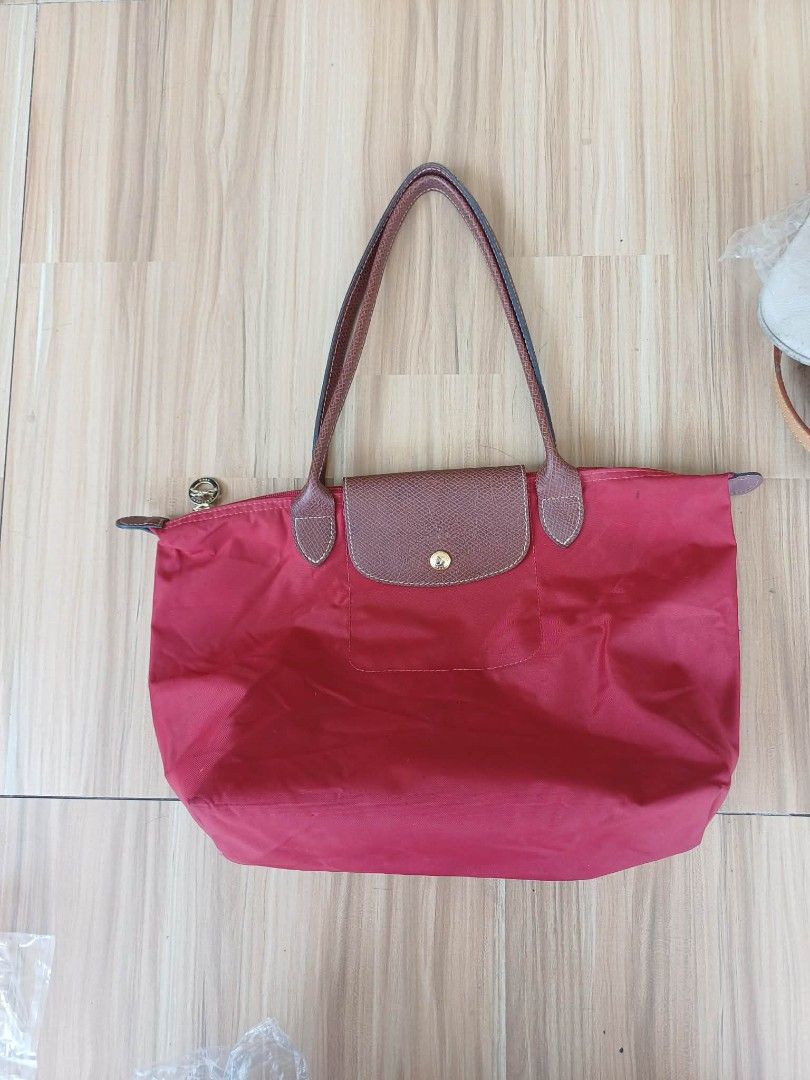 Longchamp Le Pliage Tote Bag Red (Category: Luxury Bags & Wallets) located in Bay. Submitted by silverhorse-59c851 (Listing ID 1463102924, Image 1). Description: - Classic Longchamp tote bag in a vibrant red. - Made with durable nylon and genuine leather handles. - Ample interior space for all your essentials. - Features a convenient small inner pocket. - Folds down easily for compact storage. - Ideal everyday bag for work, errands, or travel..