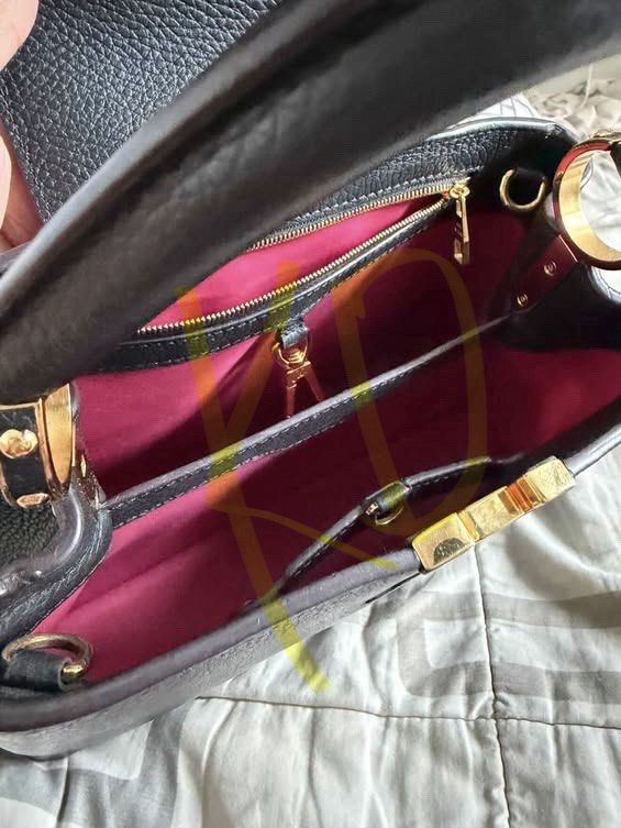Louis Vuitton Black Leather Top Handle Bag (Category: Luxury Bags & Wallets) located in Makati City. Submitted by mikimi00 (Listing ID 1462954997, Image 2). Description: - Genuine black pebbled leather - Elegant gold hardware details - Spacious interior with multiple compartments - Secure interior zip pocket - Includes a detachable shoulder strap for versatile wear - Ideal for both daily errands and special events LV Capucines size MM Color black