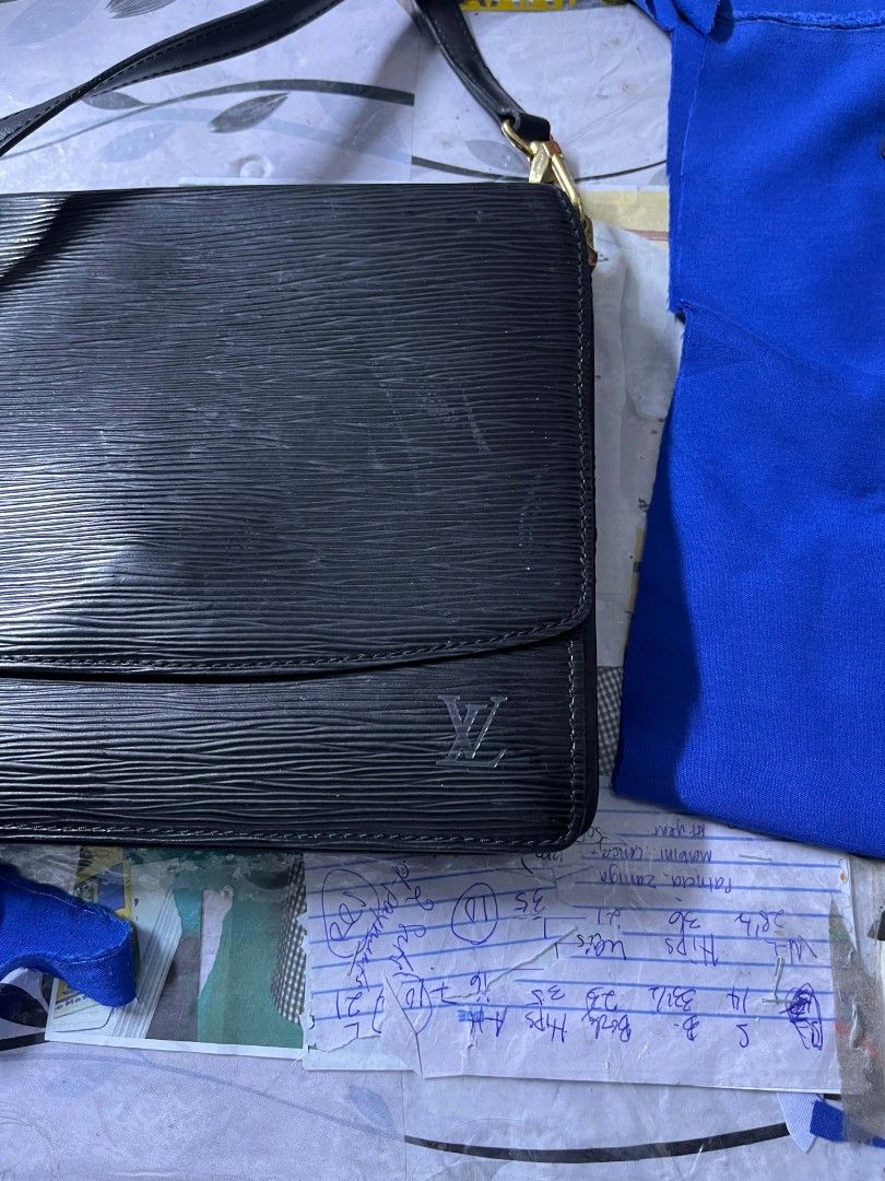 Louis Vuitton Epi Leather Shoulder Bag (Category: Luxury Bags & Wallets) located in Lapu Lapu. Submitted by margaux099 (Listing ID 1463052085, Image 2). Description: - Authentic Louis Vuitton shoulder bag - Color: Black - Material: Epi leather - Hardware: Gold-tone - Interior: A few minor marks - Serial Number: MI0935 - Approximate Dimensions: 9.5" (W) x 7" (H) - Strap: Adjustable.