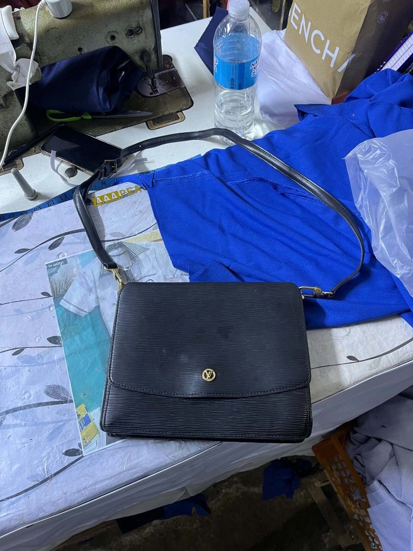 Louis Vuitton Epi Leather Shoulder Bag (Category: Luxury Bags & Wallets) located in Lapu Lapu. Submitted by margaux099 (Listing ID 1463052085, Image 1). Description: - Authentic Louis Vuitton shoulder bag - Color: Black - Material: Epi leather - Hardware: Gold-tone - Interior: A few minor marks - Serial Number: MI0935 - Approximate Dimensions: 9.5" (W) x 7" (H) - Strap: Adjustable.