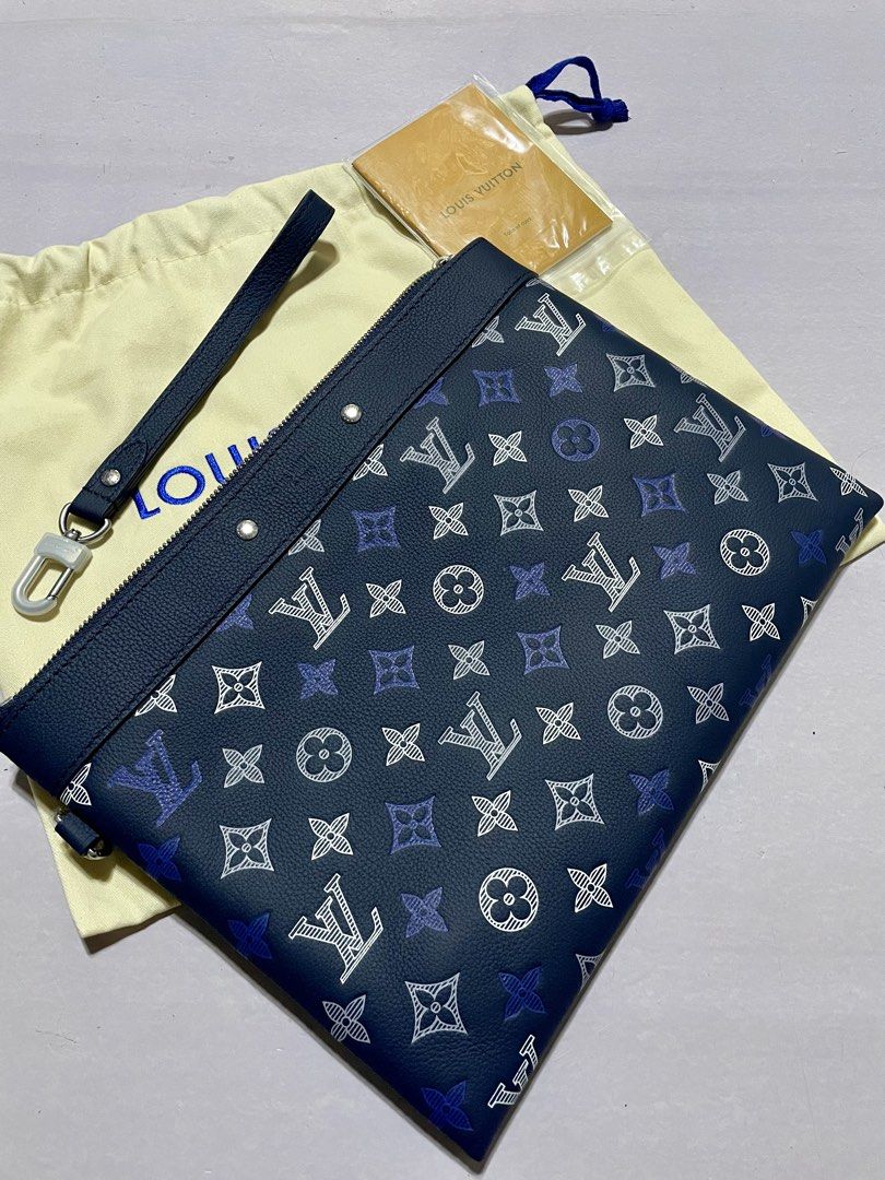 Louis Vuitton Monogram Pouch Clutch Navy Blue (Category: Luxury Bags & Wallets) located in Manila. Submitted by jyexclusivelux.ph (Listing ID 1462915187, Image 1). Description: - Color: Navy blue with iconic monogram pattern - Features leather trim and wrist strap - Interior slip pockets for organization - Comes with original dust bag and authenticity card - Versatile use: great for organizing essentials or as a standalone clutch.