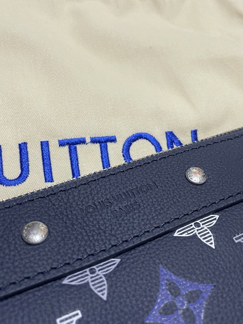 Louis Vuitton Monogram Pouch Clutch Navy Blue (Category: Luxury Bags & Wallets) located in Manila. Submitted by jyexclusivelux.ph (Listing ID 1462915187, Image 3). Description: - Color: Navy blue with iconic monogram pattern - Features leather trim and wrist strap - Interior slip pockets for organization - Comes with original dust bag and authenticity card - Versatile use: great for organizing essentials or as a standalone clutch.