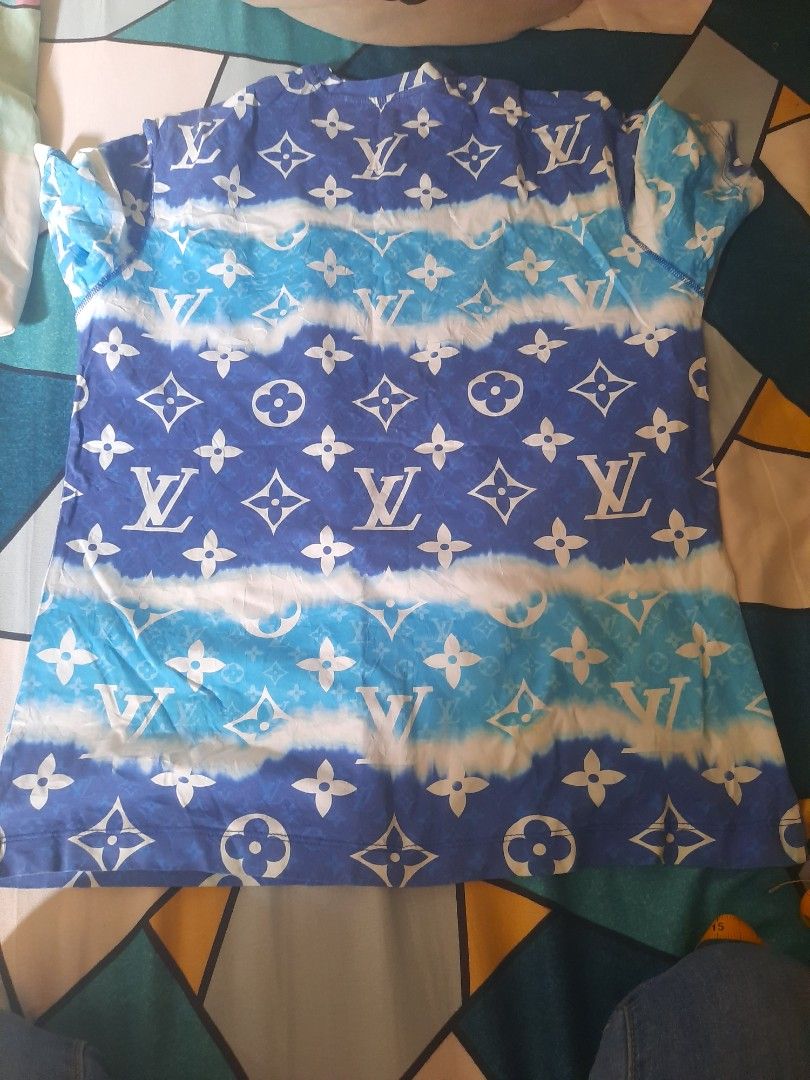 Louis Vuitton Monogram Tie-Dye T-Shirt (Category: Tshirts & Polo Shirts ) located in San Pedro. Submitted by thriftersp47808 (Listing ID 1462904998, Image 2). Description: - Trendy blue and white tie-dye tee - Features iconic LV monogram print - Made in Italy for quality craftsmanship - Size M, fits comfortably - Ideal for everyday casual wear.