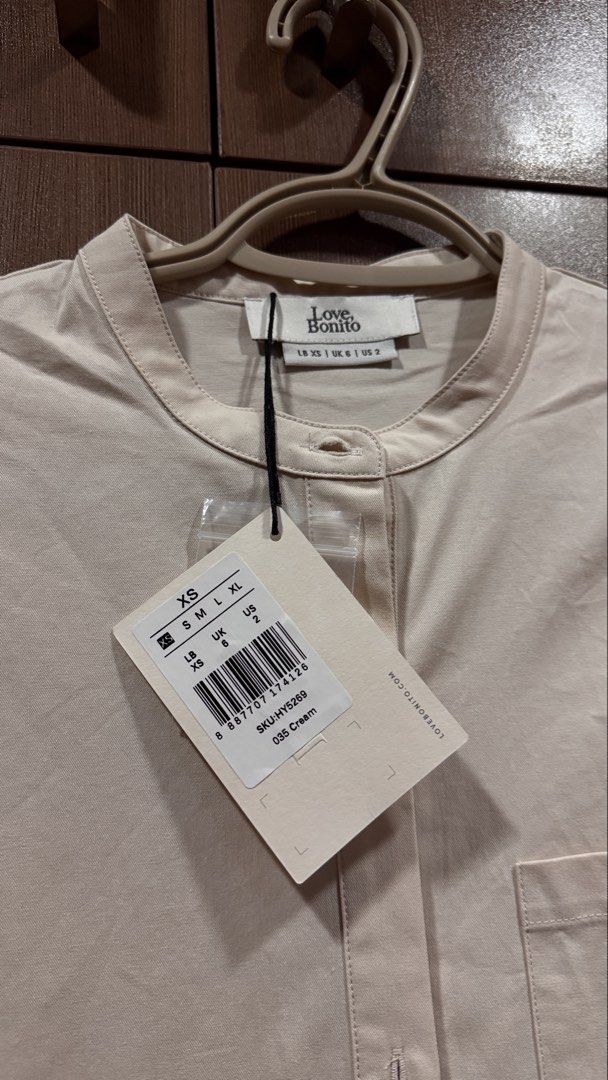 Love Bonito Cream Button Down Dress (Category: Dresses) located in Caloocan City. Submitted by zmn888 (Listing ID 1463010648, Image 2). Description: - Brand new Love Bonito button down dress - Color: Cream - Size: XS - Features: Button-up front, Mandarin collar - Material: Light cotton blend - Style: Versatile for casual or smart casual wear - Condition: Brand new with tags.