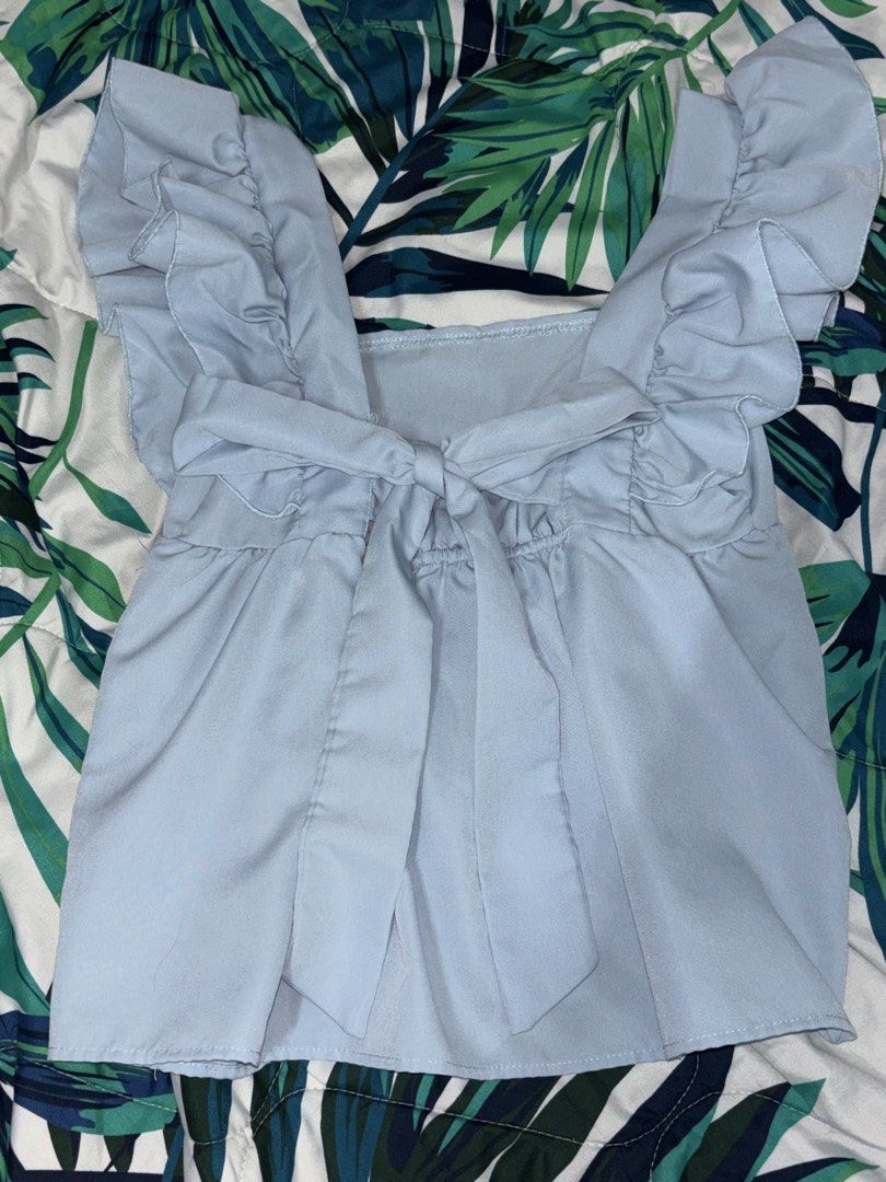 Lovito Casual Plain Bow Back Top (Category: Blouses) located in Manila. Submitted by beelvrd (Listing ID 1462999797, Image 2). Description: - Cute light blue top - Ruffle sleeves - Tie-front detail at the back - Square neckline - Free size, big on the sleeves for me.
