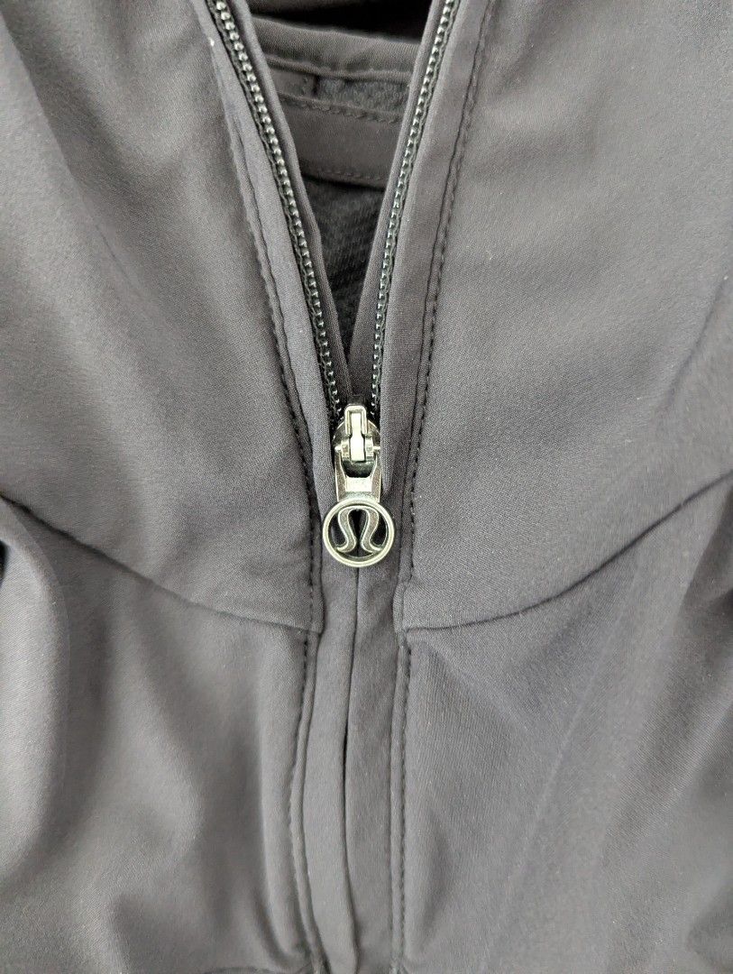 Lululemon Black Hooded Pullover Jacket (Category: Coats, Jackets and Outerwear) located in Taguig. Submitted by hlco13 (Listing ID 1462959268, Image 3). Description: - Black Lululemon athletic jacket - Features a hood for extra coverage - Convenient half-zip closure - Thumbholes on sleeves for a secure fit - Unique gathered detail with a slit opening on the back - Stylish pleated detail on the hem - Versatile for workouts or everyday casual wear.