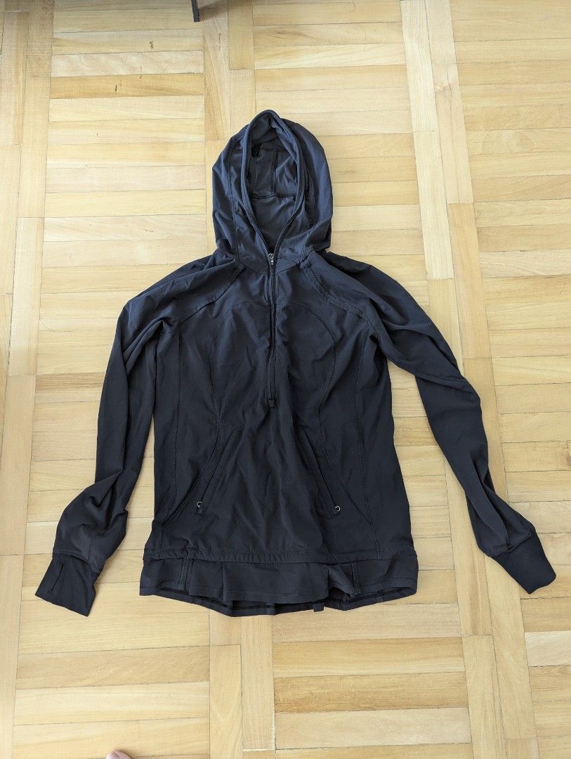 Lululemon Black Hooded Pullover Jacket (Category: Coats, Jackets and Outerwear) located in Taguig. Submitted by hlco13 (Listing ID 1462959268, Image 1). Description: - Black Lululemon athletic jacket - Features a hood for extra coverage - Convenient half-zip closure - Thumbholes on sleeves for a secure fit - Unique gathered detail with a slit opening on the back - Stylish pleated detail on the hem - Versatile for workouts or everyday casual wear.