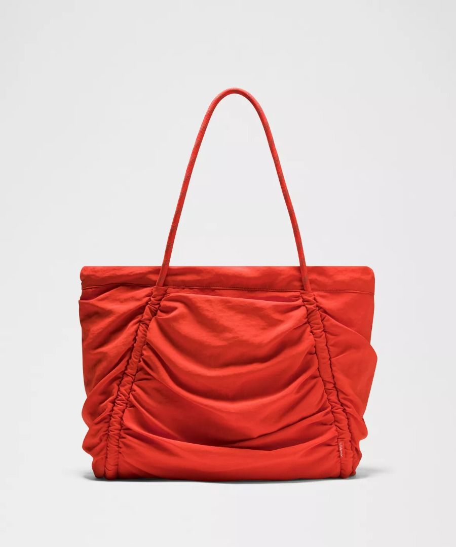 Lululemon Ruched Tote Bag 24L - Cherry Ember/Silver (Category: Tote Bags) located in Manila. Submitted by myownclosetforsale (Listing ID 1462977443, Image 3). Description: Measurements Dimensions: W 38cm x D 15cm x H 33cm (15" x 6" x 13") Handle drop: 25cm (9.8") Volume: 24L Product Features: Cinch the side drawcords to compress volume Clip a carabiner or your favourite accessories to the D-ring Interior zippered and slip pockets Interior pocket 