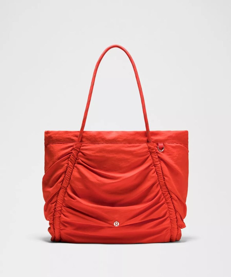 Lululemon Ruched Tote Bag 24L - Cherry Ember/Silver (Category: Tote Bags) located in Manila. Submitted by myownclosetforsale (Listing ID 1462977443, Image 1). Description: Measurements Dimensions: W 38cm x D 15cm x H 33cm (15" x 6" x 13") Handle drop: 25cm (9.8") Volume: 24L Product Features: Cinch the side drawcords to compress volume Clip a carabiner or your favourite accessories to the D-ring Interior zippered and slip pockets Interior pocket 