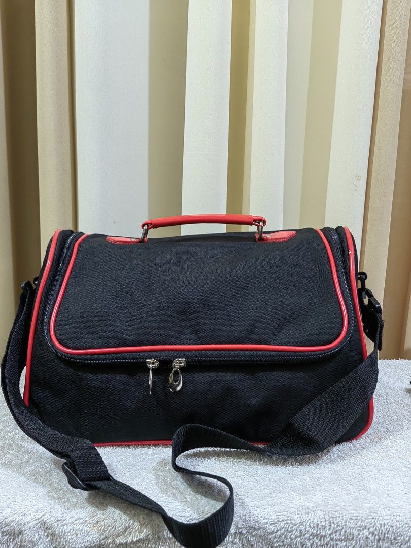 Makeup on the Go Bag with Multiple Compartments (Category: Makeup) located in Makati City. Submitted by prelovedtreatedwithlove (Listing ID 1462975903, Image 1). Description: - Stylish black duffle bag with eye-catching red trim. - Spacious main compartment with built-in organizers for easy packing. - Convenient zippered pocket on the top flap for quick access to essentials. - Handy mesh pocket for storing wet items or water bottles. - Comes with