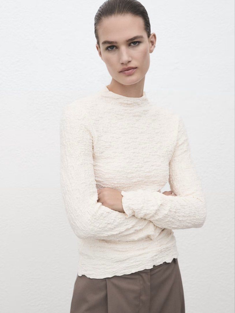 MANGO Textured Mock Neck Long Sleeve Top M (Category: Longsleeves) located in Cagayan de Oro. Submitted by jeirn (Listing ID 1463117847, Image 1). Description: - Brand: MANGO - Style: Long sleeve top - Color: Cream - Neckline: Mock neck - Fabric: Unique crinkle texture all over - Size: Medium (M) - Condition: Brand new, never worn - Versatile: Great on its own or for layering.