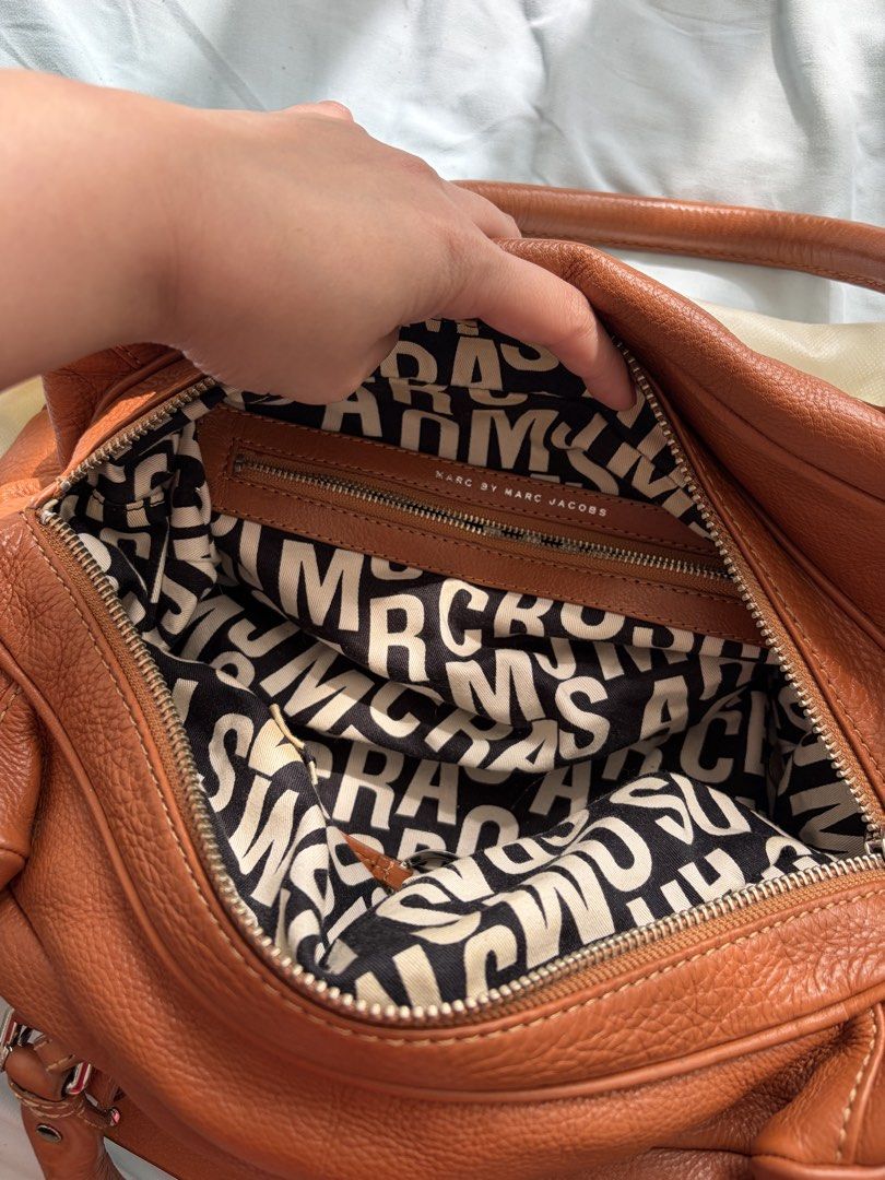 Marc by Marc Jacobs Standard Supply Leather Handbag (Category: Luxury Bags & Wallets) located in Quezon City. Submitted by moonxxchild (Listing ID 1462947597, Image 3). Description: - Authentic Marc by Marc Jacobs Standard Supply handbag - Rich brown leather with a beautiful texture - Spacious zippered main compartment - Interior zippered pocket for essentials - Signature Marc by Marc Jacobs logo lining.