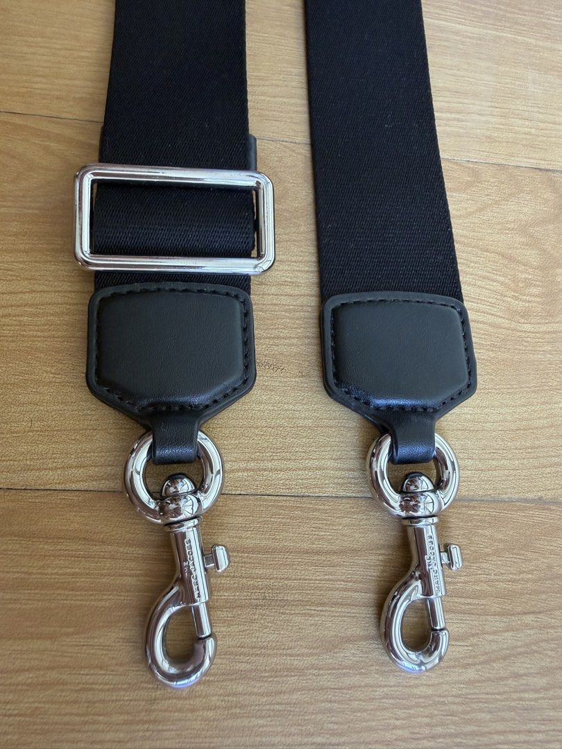 Marc Jacobs Bag strap (Category: Cross-body Bags) located in Bacolor. Submitted by ieshaaa.1 (Listing ID 1462893243, Image 2). Description: - Durable black fabric with leather accents - Sturdy silver swivel clasps for easy attachment - Adjustable length - Perfect for bag replacement or customization.