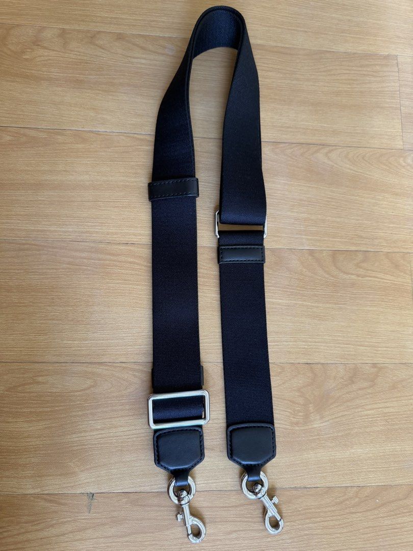 Marc Jacobs Bag strap (Category: Cross-body Bags) located in Bacolor. Submitted by ieshaaa.1 (Listing ID 1462893243, Image 1). Description: - Durable black fabric with leather accents - Sturdy silver swivel clasps for easy attachment - Adjustable length - Perfect for bag replacement or customization.