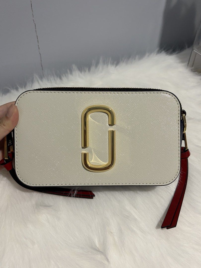 Marc Jacobs The Snapshot Crossbody Bag (Category: Luxury Bags & Wallets) located in Davao. Submitted by mgnmm (Listing ID 1463041500, Image 2). Description: - Authentic Marc Jacobs Snapshot Camera Bag - Color: 143 - Coconut Multi - Signature Gold Double J hardware - Dual zip compartments for organized storage - Includes original adjustable strap - Comes with original dust bag - Never used. Brand new. - Ideal for everyday wear and versatile stylin