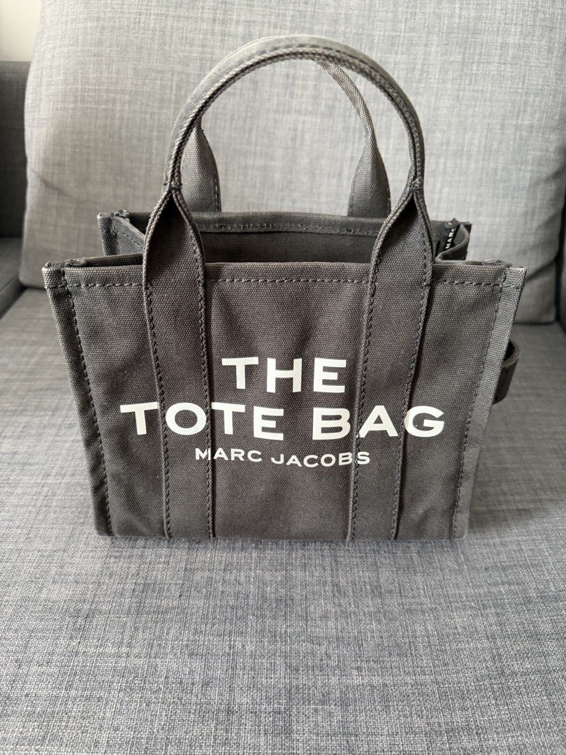 Marc Jacobs The Tote Bag Black Canvas Small (Category: Luxury Bags & Wallets) located in Manila. Submitted by royalfalcon_500ba3 (Listing ID 1462986741, Image 1). Description: - Authentic Marc Jacobs Small Tote Bag (M0016493) - Style: Small Tote Bag - Color: Black Canvas - Features: Signature 'The Tote Bag' logo in white - Closure: Zipper - Interior: Zipped pocket and slip pockets - Ideal for: Everyday use - Used only 4 times - Selling because I’