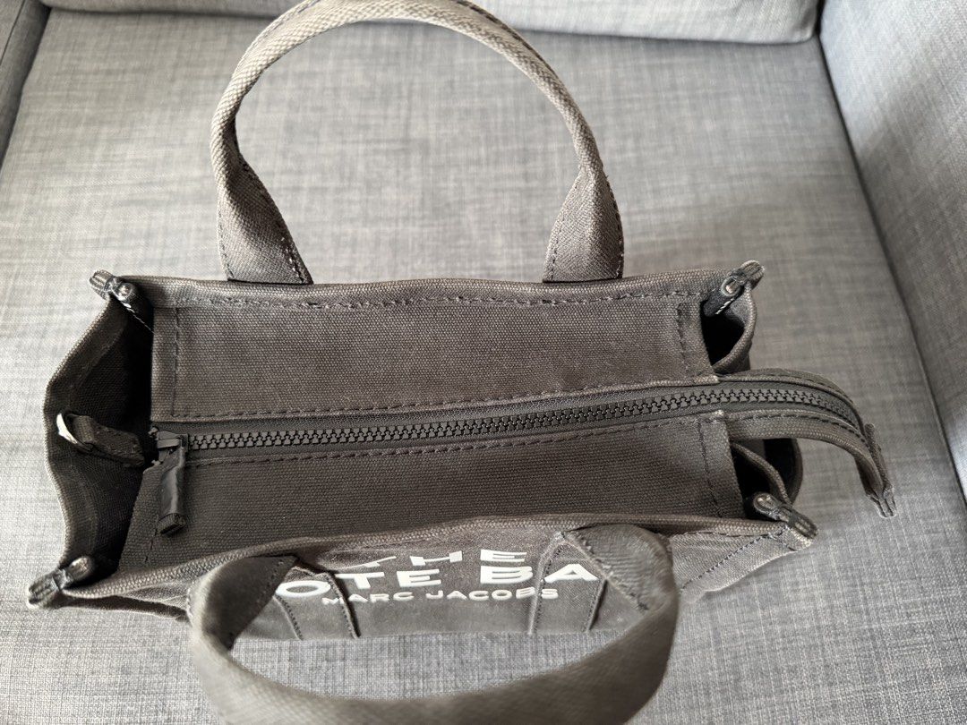 Marc Jacobs The Tote Bag Black Canvas Small (Category: Luxury Bags & Wallets) located in Manila. Submitted by royalfalcon_500ba3 (Listing ID 1462986741, Image 3). Description: - Authentic Marc Jacobs Small Tote Bag (M0016493) - Style: Small Tote Bag - Color: Black Canvas - Features: Signature 'The Tote Bag' logo in white - Closure: Zipper - Interior: Zipped pocket and slip pockets - Ideal for: Everyday use - Used only 4 times - Selling because I’