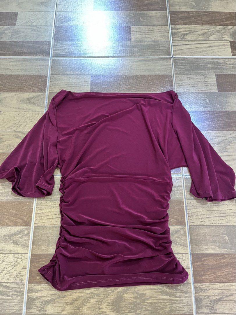 Maroon Off-Shoulder Ruched Top (Category: Dresses) located in Sorsogon. Submitted by onthedailly (Listing ID 1461010134, Image 1). Description: Maroon off-shoulder top. Flattering ruched detail on the side. Wide, flowy sleeves. Stretchy and comfortable fabric. mop: gcash/maribank courier: j&t loc: sor city (bicol).