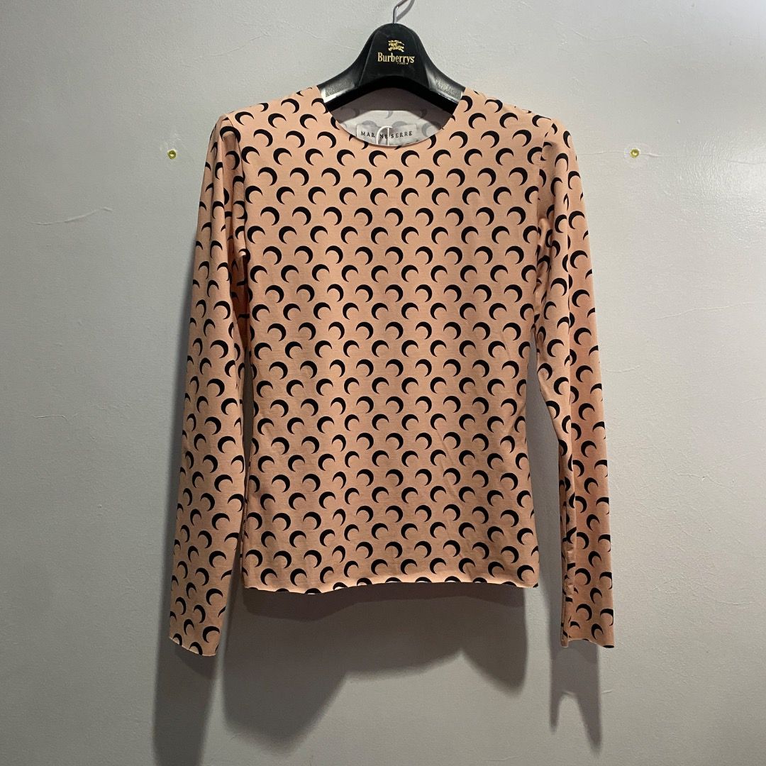 Marine Serre Moon Second Skin Top S/M (Category: Blouses) located in Antipolo. Submitted by bentakahitanoano (Listing ID 1463029676, Image 2). Description: The Marine Serre All Over Moon Second Skin Crewneck Top is a signature piece from the French designer Marine Serre, easily recognized by its iconic crescent moon monogram pattern. Designed to fit closely like a "second skin," this long-sleeved, crewneck jersey shirt features raw-edge cuffs and