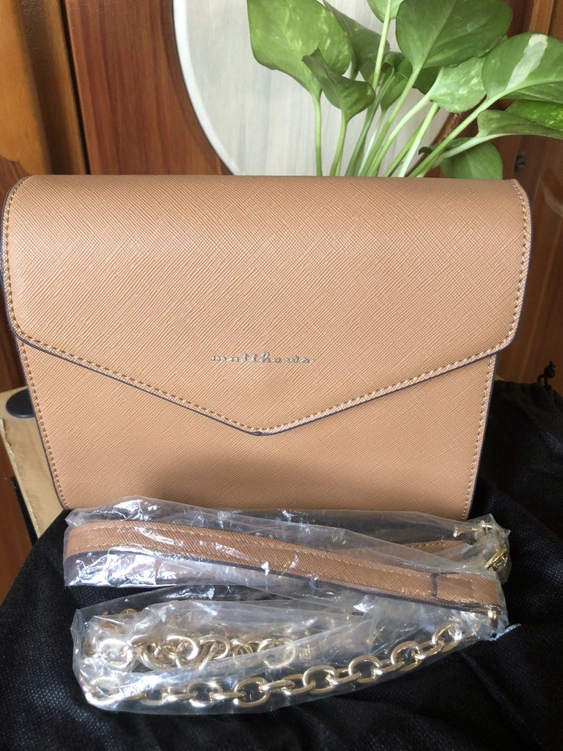 Matthews Tan Saffiano Leather Envelope Shoulder Bag (Category: Shoulder Bags) located in Makati City. Submitted by mitchi_koy28 (Listing ID 1462947266, Image 1). Description: - Matthews tan shoulder bag - Saffiano leather texture - Envelope flap closure with magnetic snap - Detachable leather strap included - Gold chain strap included - Dust bag included - Versatile for day or night use - used once.