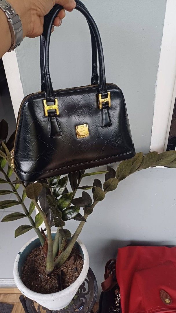 MCM Black Monogram Dome Satchel Handbag (Category: Luxury Bags & Wallets) located in Bay. Submitted by silverhorse-59c851 (Listing ID 1463102816, Image 1). Description: - Classic black MCM dome satchel - All-over MCM monogram pattern - Gold hardware details - Secure zipper closure - Interior with MCM lining and gold plaque - Smooth, comfortable handles - Perfect stylish everyday bag.