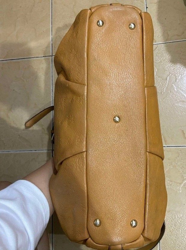 MCM Monogram Leather Tote Bag (Category: Luxury Bags & Wallets) located in Bay. Submitted by silverhorse-59c851 (Listing ID 1463102869, Image 2). Description: - Authentic brown MCM tote bag - Signature all-over monogram print - Crafted from quality leather - Comfortable top handles - Includes a detachable shoulder strap for versatility - Elegant gold-tone hardware - Minor signs of wear on leather and strap, adding character - Interior is clean an