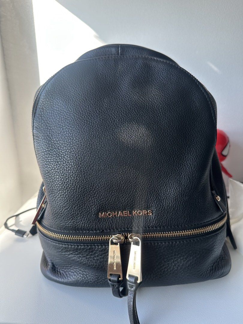 Michael Kors Black Leather Backpack Gold Hardware (Category: Backpacks) located in Pasig City. Submitted by staceylouieyu (Listing ID 1462908001, Image 2). Description: - Authentic Michael Kors black leather backpack - Elegant gold hardware on zippers and buckles - Ample interior space for essentials - Perfect for everyday use or travel - Inclusion: dustbag.