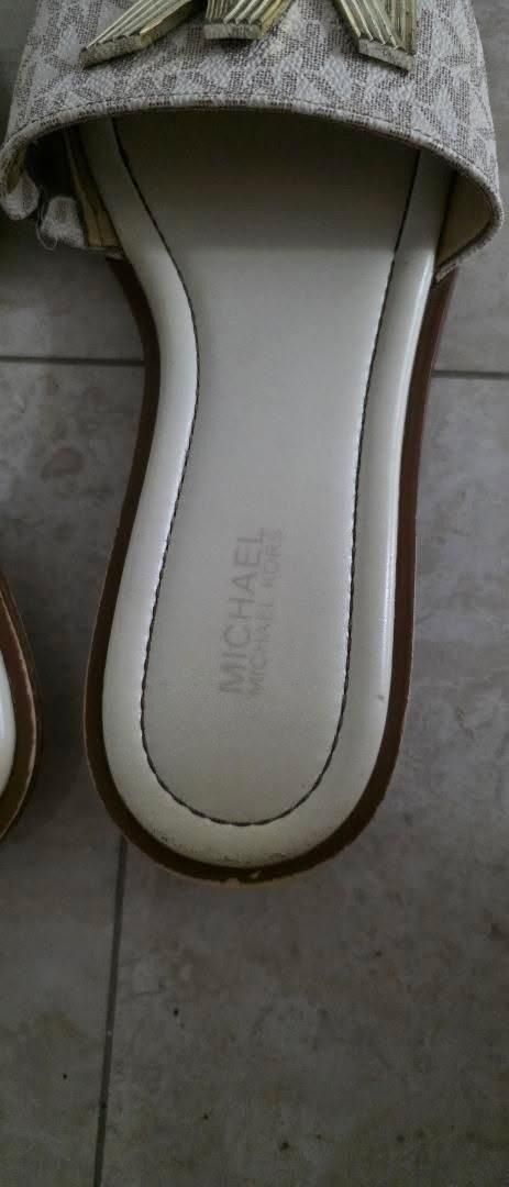 Authentic Michael Kors MK Logo Slides Sandals (Category: Sneakers & Footwear) located in Angeles City. Submitted by miho066_ (Listing ID 1462987867, Image 3). Description: - Authentic Michael Kors slides - Iconic MK logo pattern - Chic cream and gold colorway - Easy slip-on design - Comfortable footbed with embossed Michael Kors logo - Ideal for everyday casual wear.