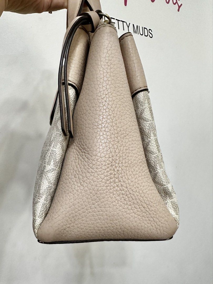 Michael Kors Monogram Satchel Bag (Category: Luxury Bags & Wallets) located in Cardona. Submitted by jaxdelossa10453 (Listing ID 1463006465, Image 3). Description: - Authentic Michael Kors satchel bag -missing strap - Classic beige and white MK monogram print - Elegant textured leather trim in a light pinkish-beige hue - Stylish gold hardware accents - Comfortable top handles - Includes a detachable charm for added flair - Ideal for everyday wear