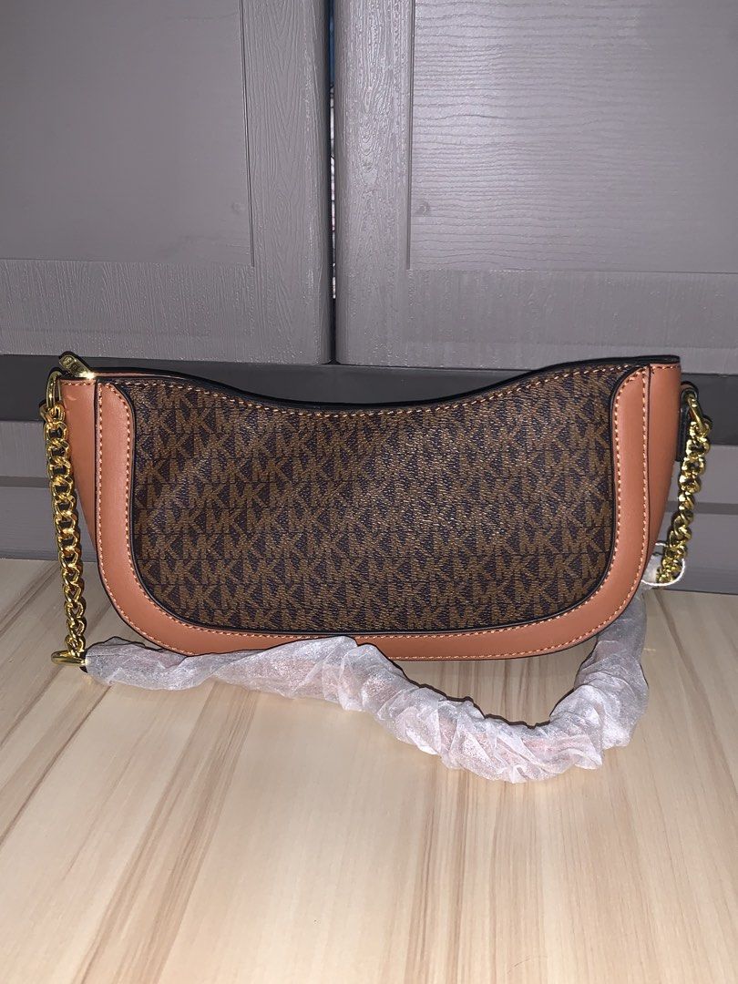 Michael Kors Monogram Shoulder Bag (Category: Luxury Bags & Wallets) located in Manila. Submitted by jo.arban (Listing ID 1462894285, Image 3). Description: - Authentic Michael Kors shoulder bag - Classic MK monogram print - Tan leather trim - Gold chain strap - Includes dust bag and original tag - Versatile for everyday or evening wear.