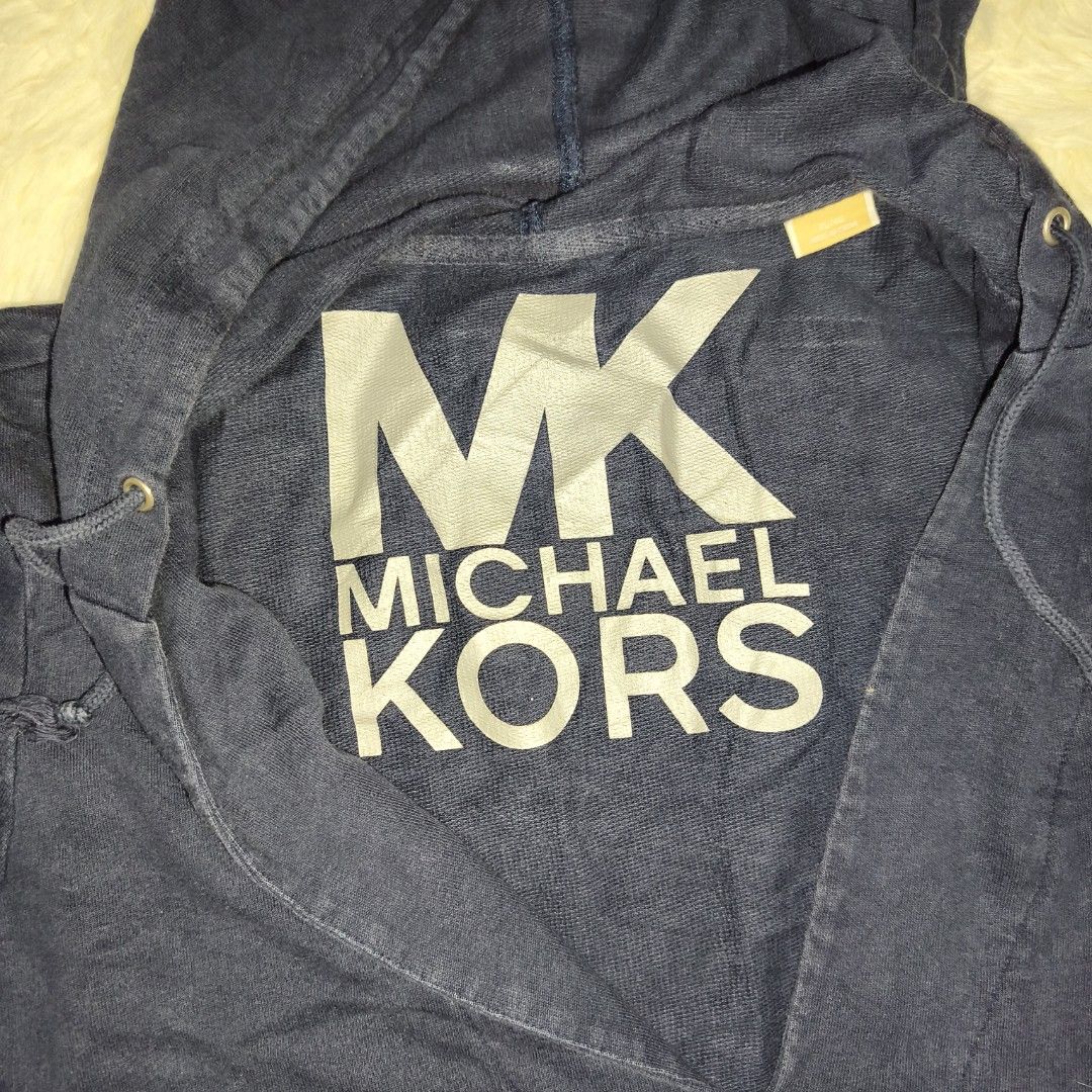 Michael Kors Navy Blue Hoodie (Category: Coats, Jackets and Outerwear) located in Antipolo. Submitted by alphaomega_fox (Listing ID 1462897291, Image 3). Description: - Navy blue Michael Kors hoodie - Size: XL/XG - Features iconic MK logo on the front - Subtle MK detail on the sleeve - Adjustable drawstring hood - Convenient kangaroo pocket - 23x28.5 250 plus sf.