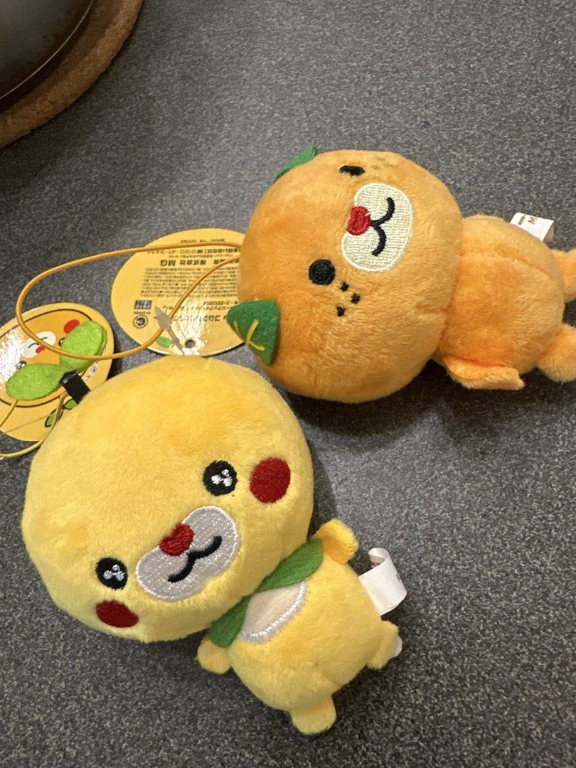 Mikyan and Komikyan plush set (Category: Plushies & Soft Toys) located in Cainta. Submitted by shopbyyna (Listing ID 1463008943, Image 3). Description: - Adorable fruit plushies set! - One yellow plush with green leaf sprout. - One orange plush with green leaves. - Both feature cute embroidered faces. - Comes with original tags attached. - Super soft and cuddly material. - Ideal for collecting or as a delightful gift. - Perfect for kids and fruit