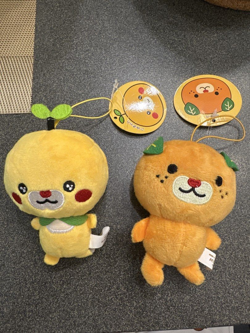 Mikyan and Komikyan plush set (Category: Plushies & Soft Toys) located in Cainta. Submitted by shopbyyna (Listing ID 1463008943, Image 1). Description: - Adorable fruit plushies set! - One yellow plush with green leaf sprout. - One orange plush with green leaves. - Both feature cute embroidered faces. - Comes with original tags attached. - Super soft and cuddly material. - Ideal for collecting or as a delightful gift. - Perfect for kids and fruit